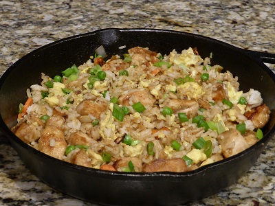 Finished fried rice displayed in a cast iron pan.