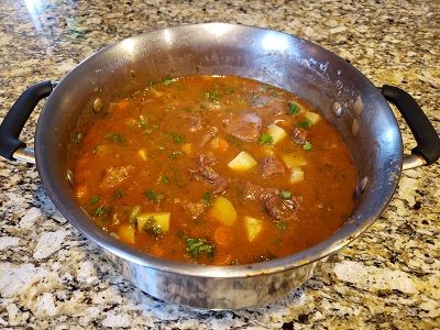 Finished beef stew in a large stock pot.